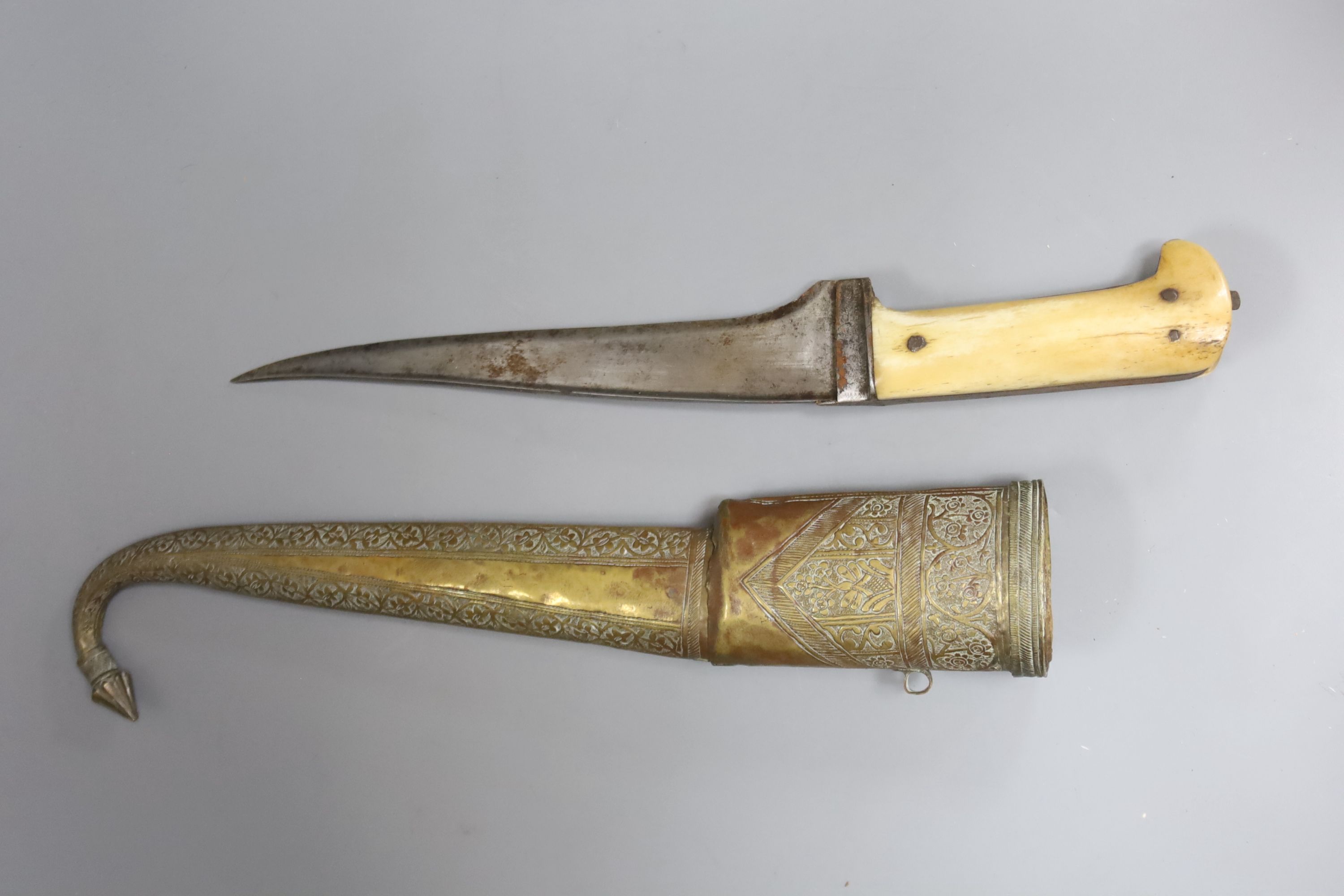 A near Eastern dagger with associated scabbard and a priest or drum stick